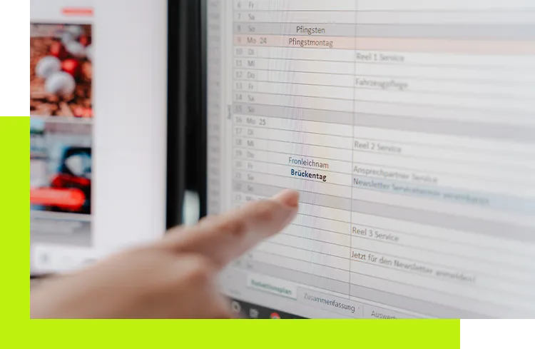 Content Strategie entwickeln lassen - Finger zeigt auf einen Redaktionskalender mit markierten Terminen während der strategischen Content-Planung