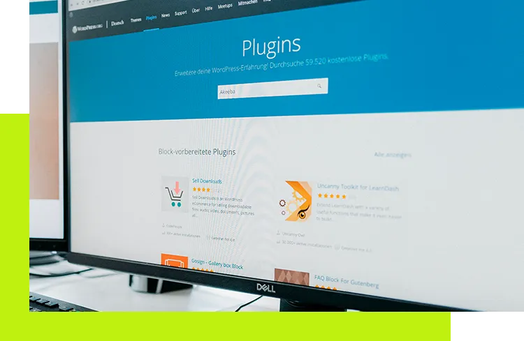 Shopware Plugin - Monitor zeigt die WordPress-Plugin-Übersicht mit Suchfeld und verschiedenen Plugin-Kacheln